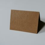 brown hardbound book on white surface
